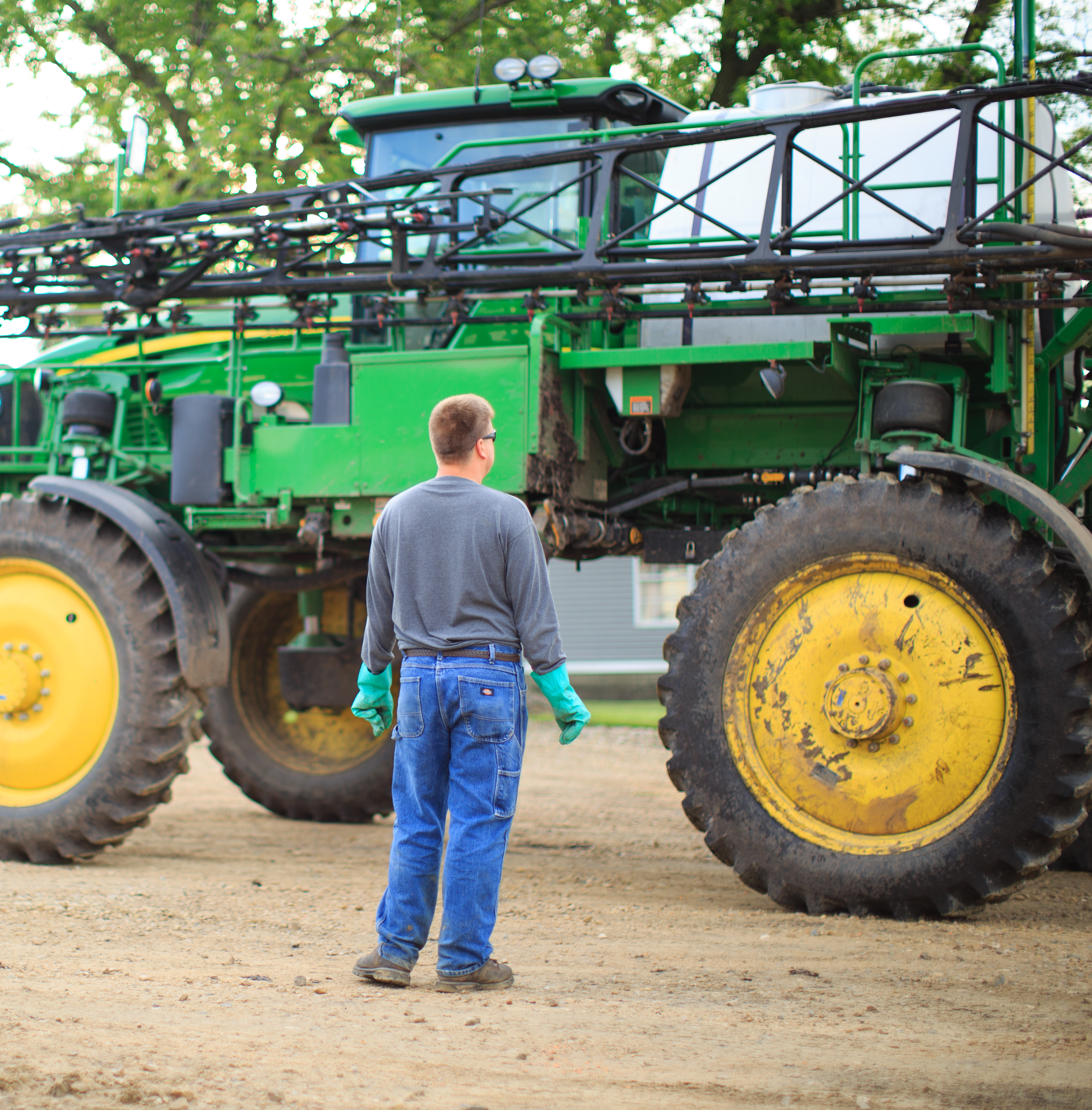 Farmer examining green sprayer